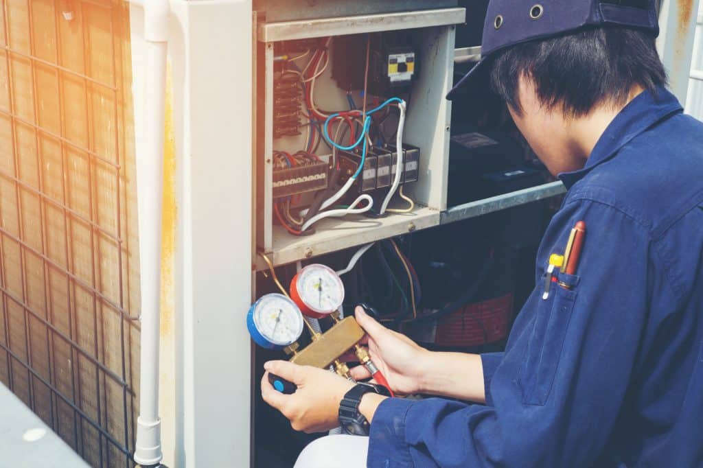 Technician is checking air conditioner